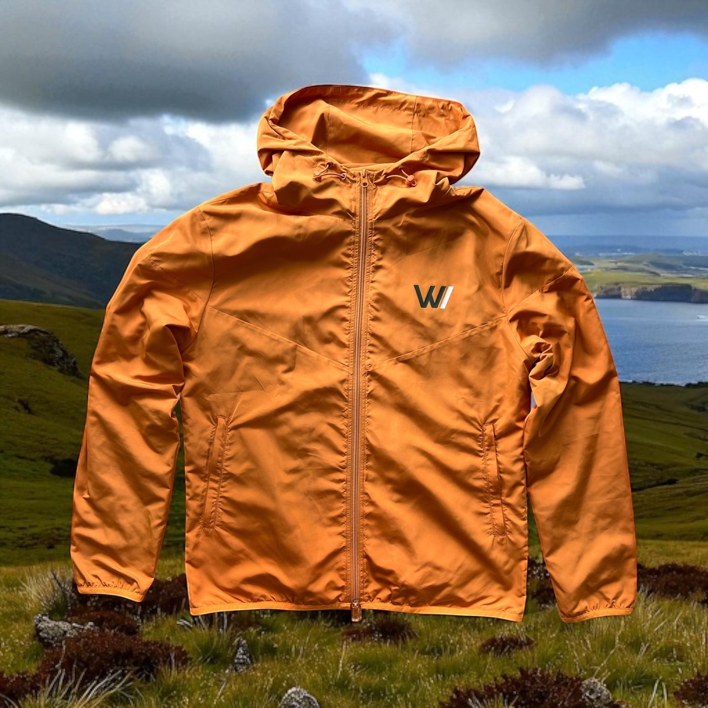 W/end windbreaker jacket in hot ember orange, lightweight synthetic material, zip fastening, hood, and logo on chest.
