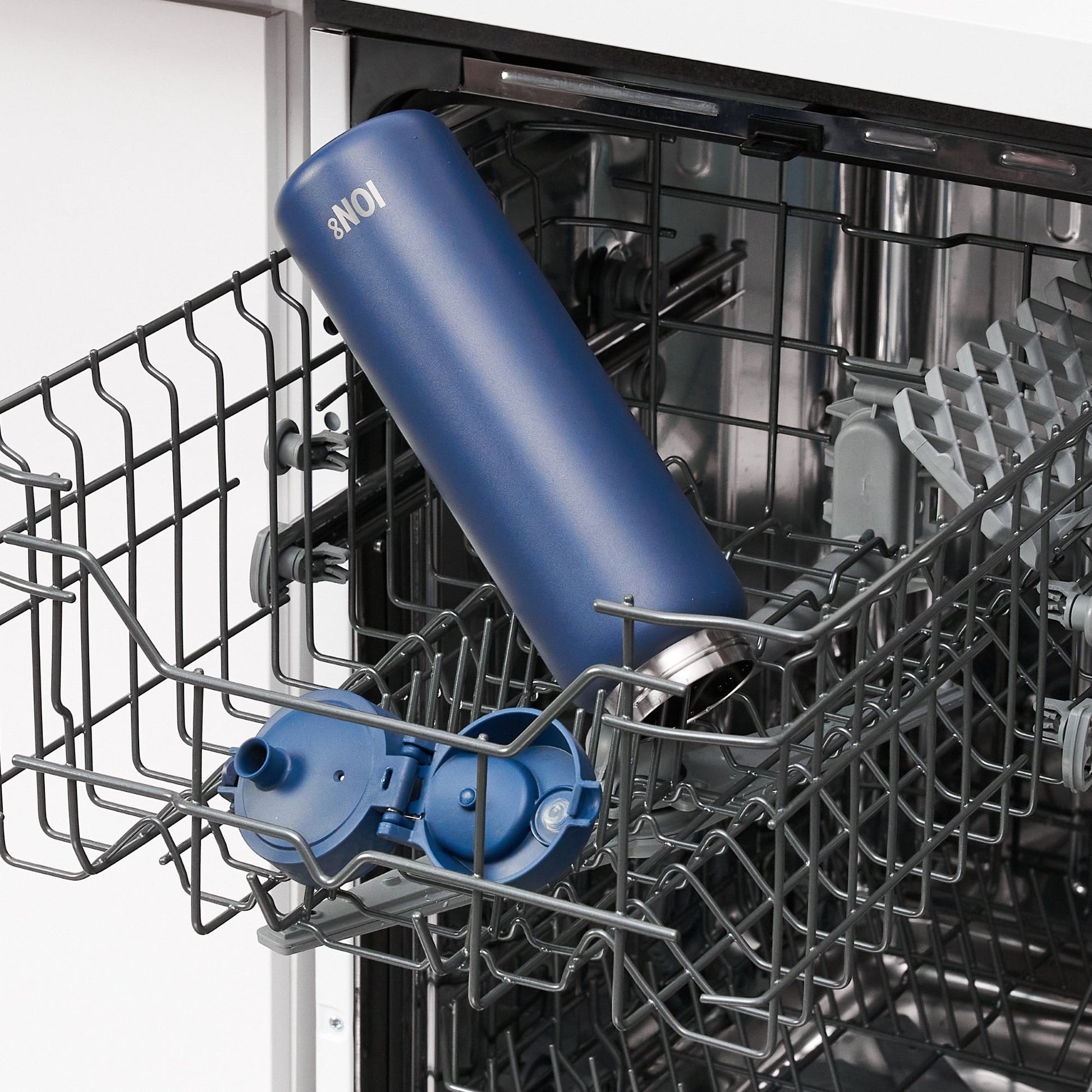 W/end ION8 1L Navy blue stainless steel thermal water bottle with flip lid, placed in dishwasher.