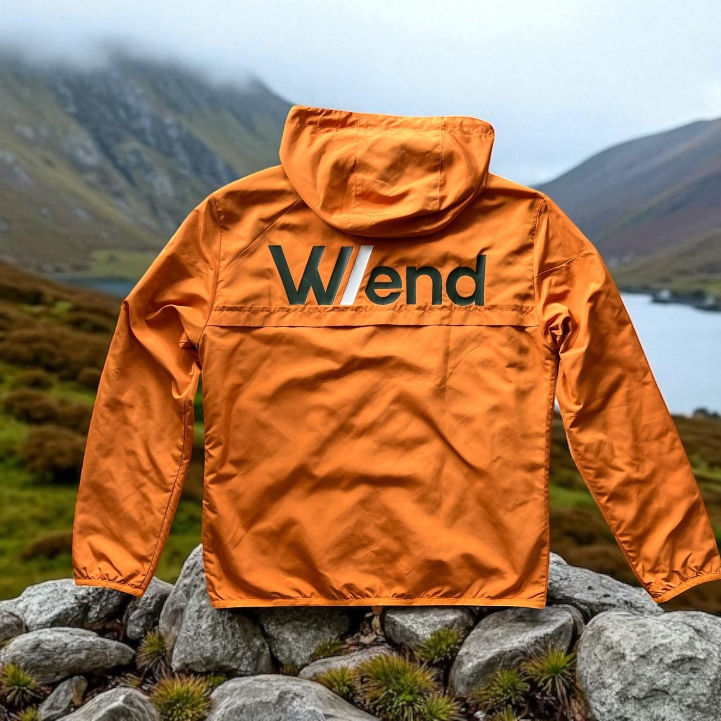 W/end windbreaker jacket in hot ember orange, lightweight and wind-resistant with a hood and zip fastening.